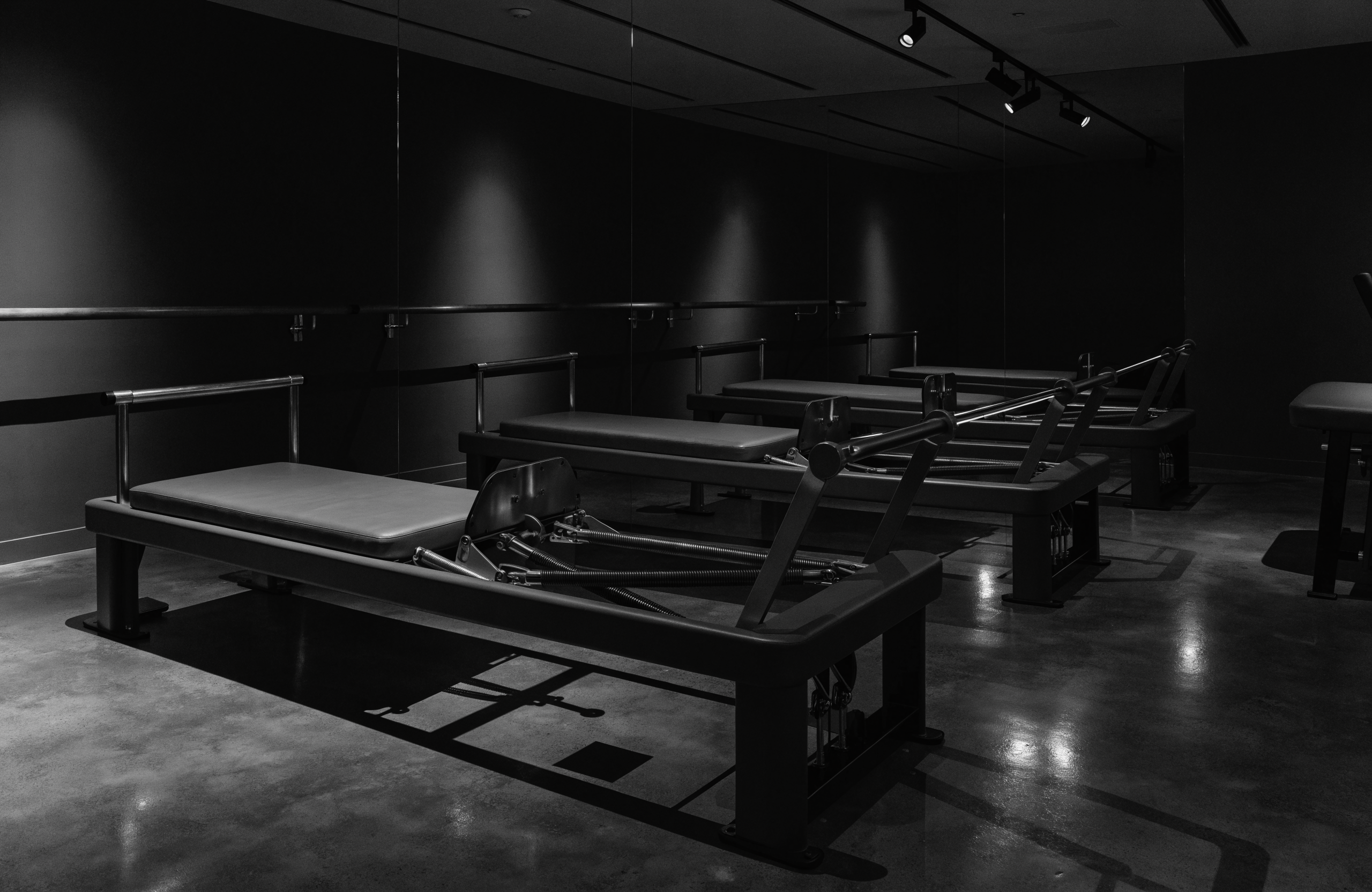 Illustrative image of a sleek modern reformer pilates and barre studio