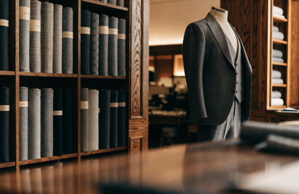 Illustrative image of a menswear tailoring atelier with a three-piece suit on a mannequin