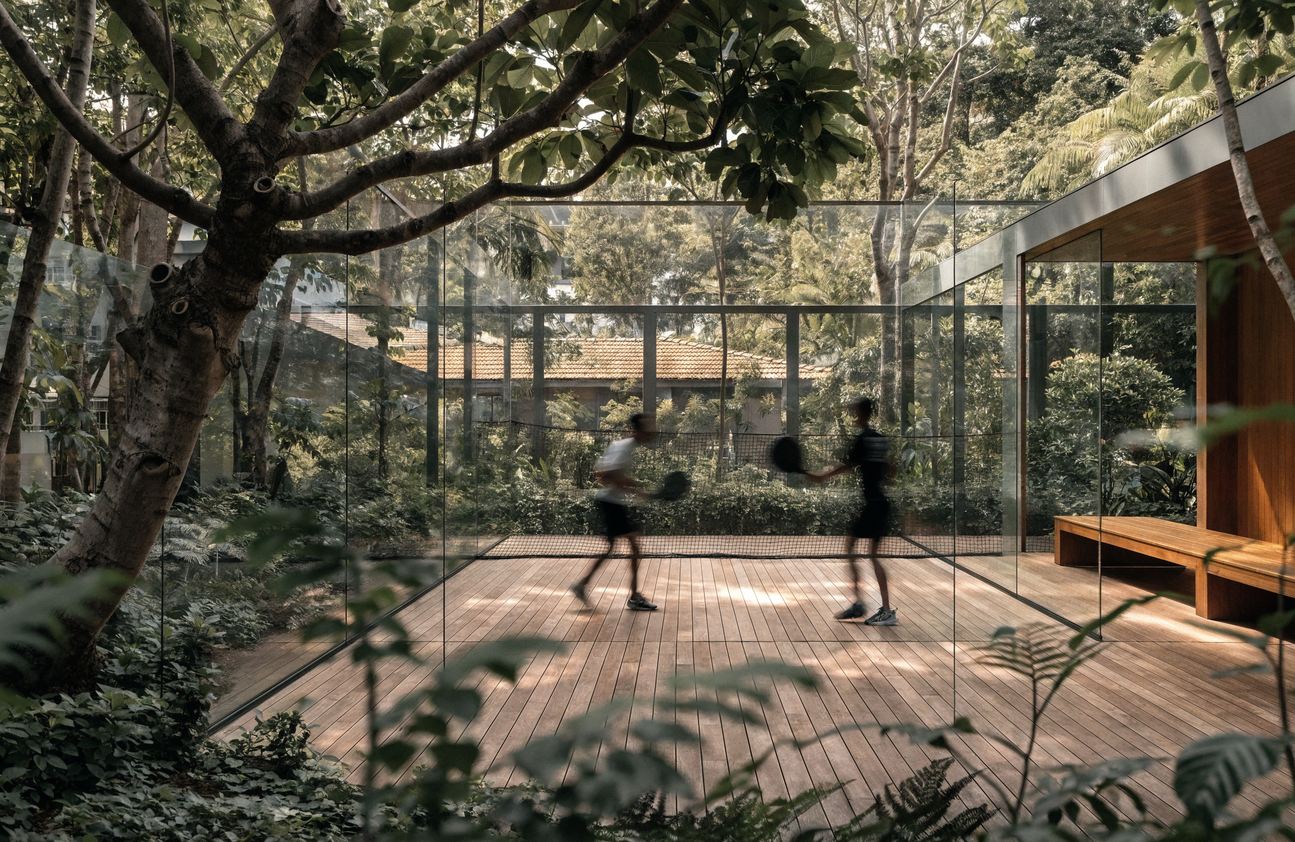 Illustrative semi-outdoor padel court surrounded by greenery, representing Prime Padel in Singapore
