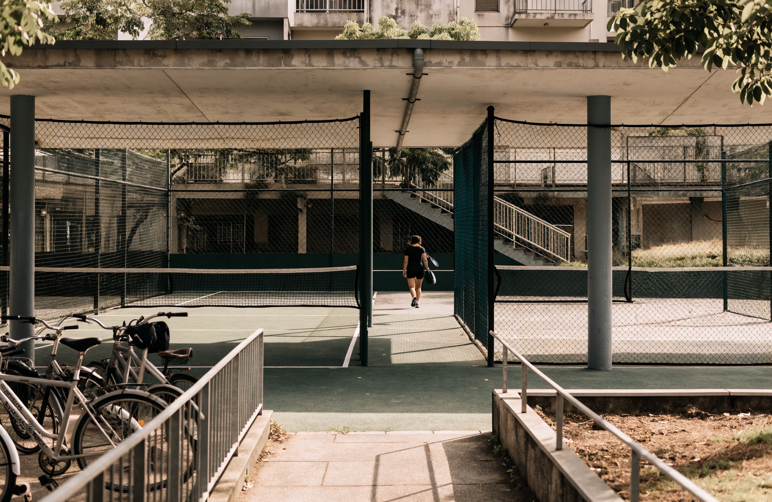 Illustrative heartland sports hub with padel and pickleball courts, representing Love All in Singapore