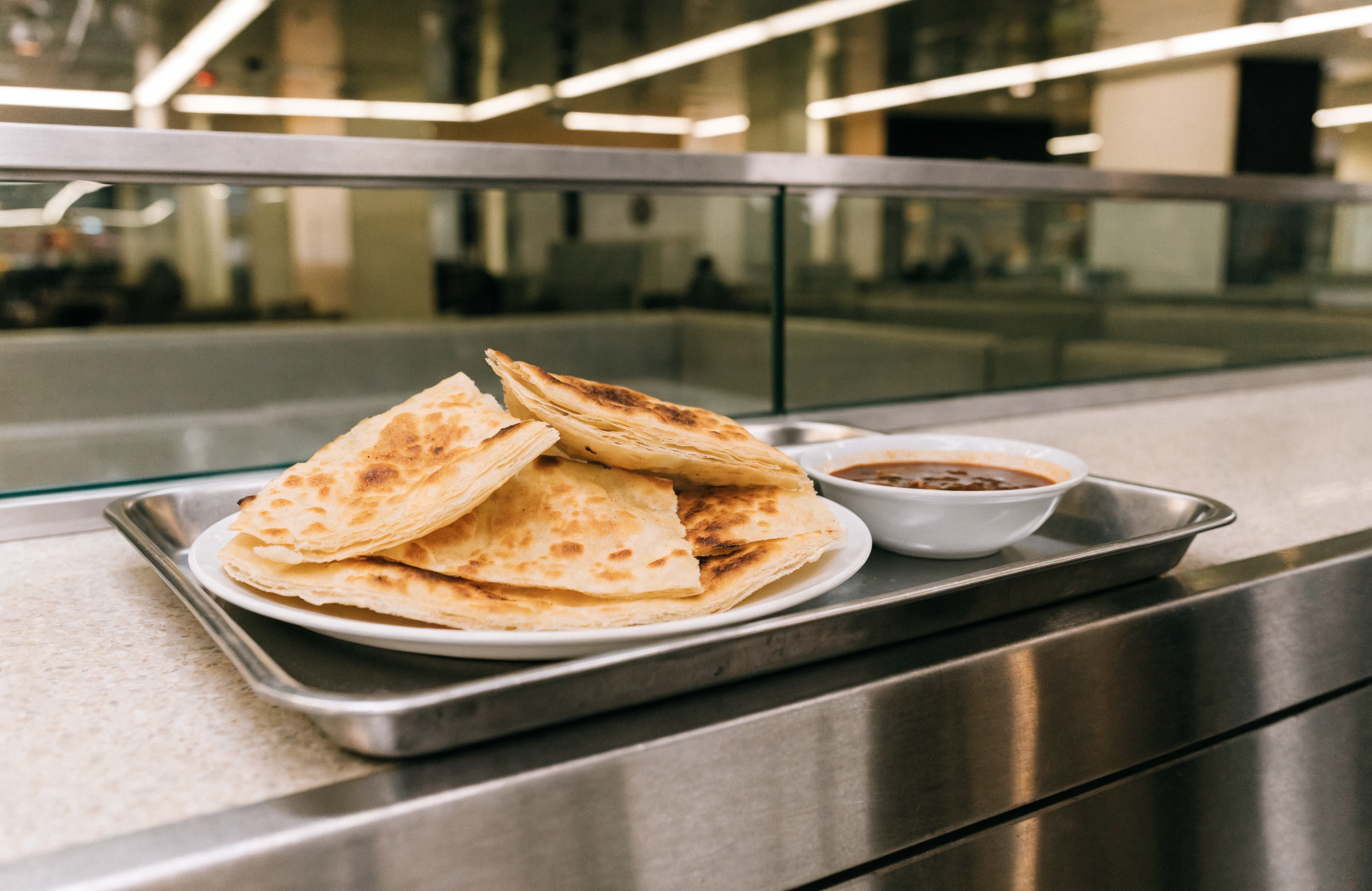Illustrative image of crispy roti prata with curry dip