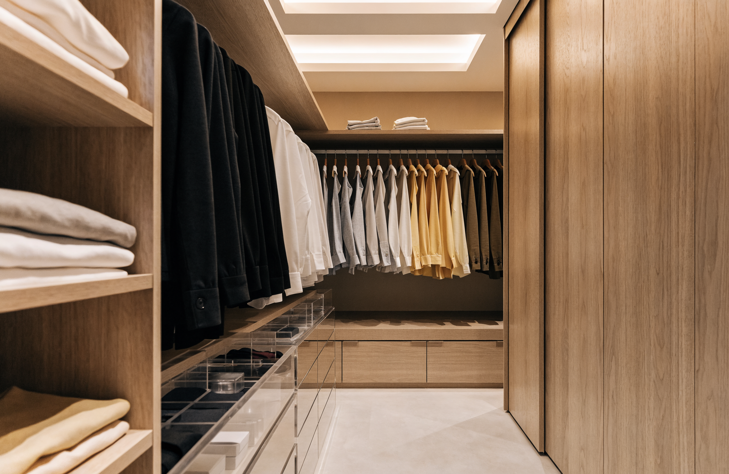 Illustrative image of an organised walk-in wardrobe, representing Kalm Organise home organising services in Singapore
