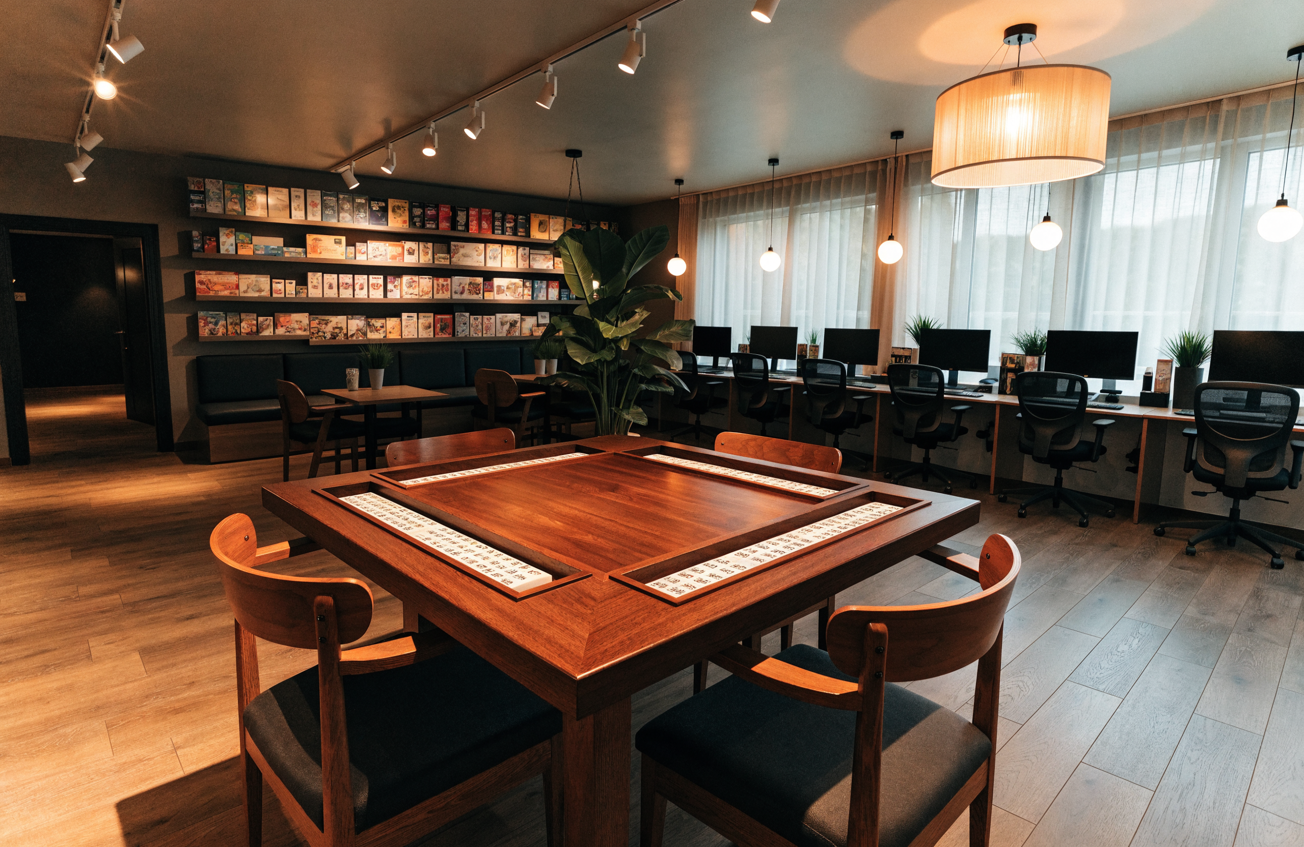 Illustrative image of a casual gaming cafe interior with a mahjong table, representing ME Games mahjong experiences in Singapore